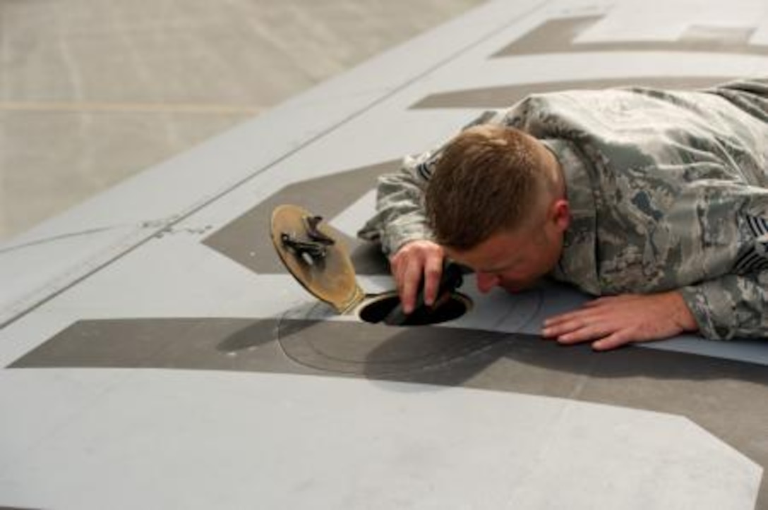 U.S. Air Force Tech. Sgt. Bradley Harrell, crew chief, 94th Airlift Wing, Dobbins Air Reserve Base, Ga., performs a basic post-flight inspection on a C-130H Hercules aircraft during Maple Flag in Edmonton/Cold Lake, Alberta, Canada, May 27, 2014. Maple Flag is an international exercise designed to enhance the interoperability of C-130 aircrews, maintainers and support specialists in a simulated combat environment. (U.S. Air Force photo by Tech. Sgt. Matthew Smith/Released)