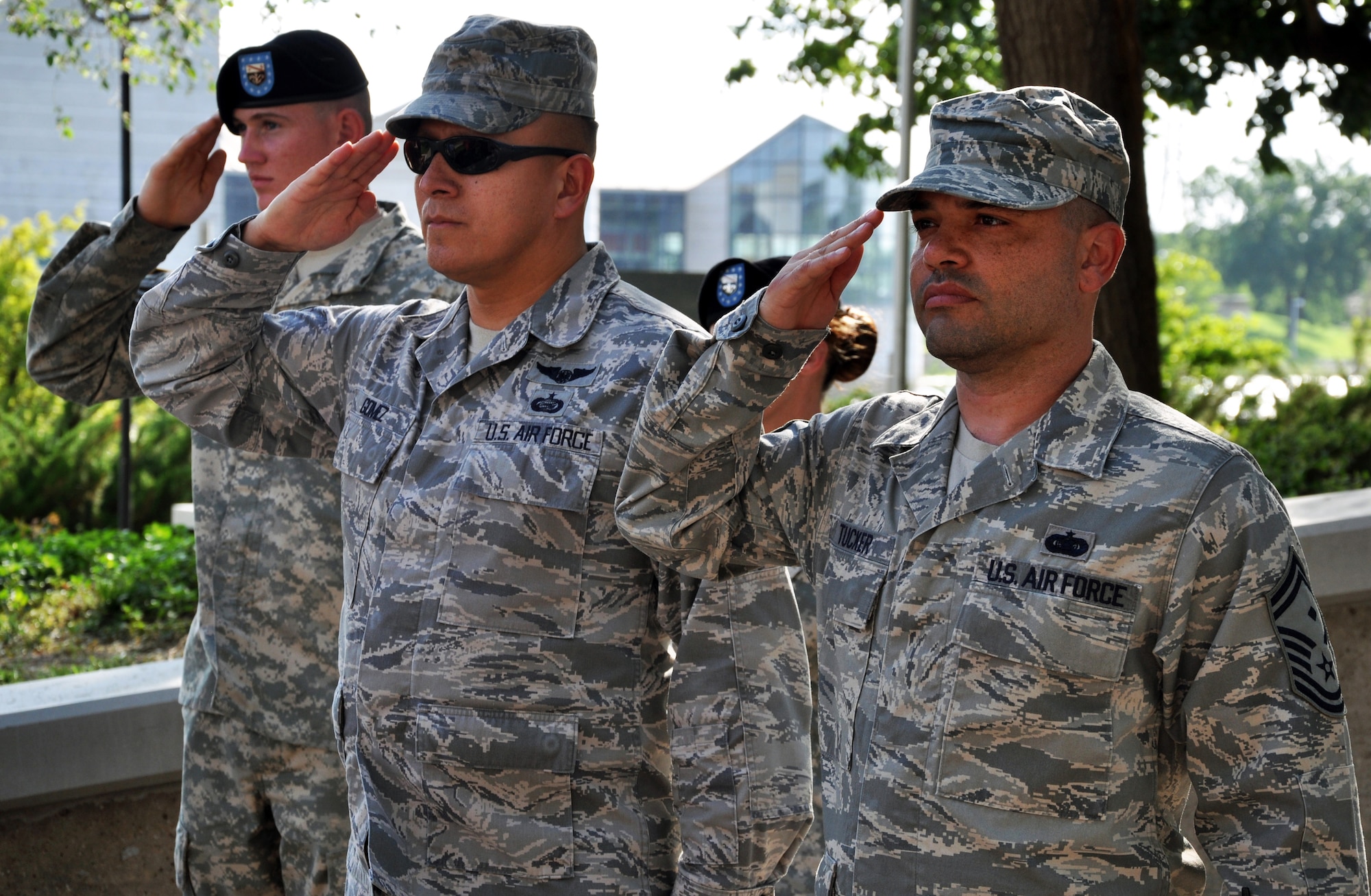 Tech. Sgt. Edward Gomez and Senior Master Sgt. Willie Tucker, 931st Air Refueling Group, McConnell Air Force Base, Kan., salute the U.S. flag during the playing of the National Anthem at the Wichita Riverfest Military Salute Ceremony in Wichita, Kan., June 3, 2014.  The annual ceremony pays tribute to past and present members of the U.S. military.  (U.S. Air Force photo by Capt. Zach Anderson)