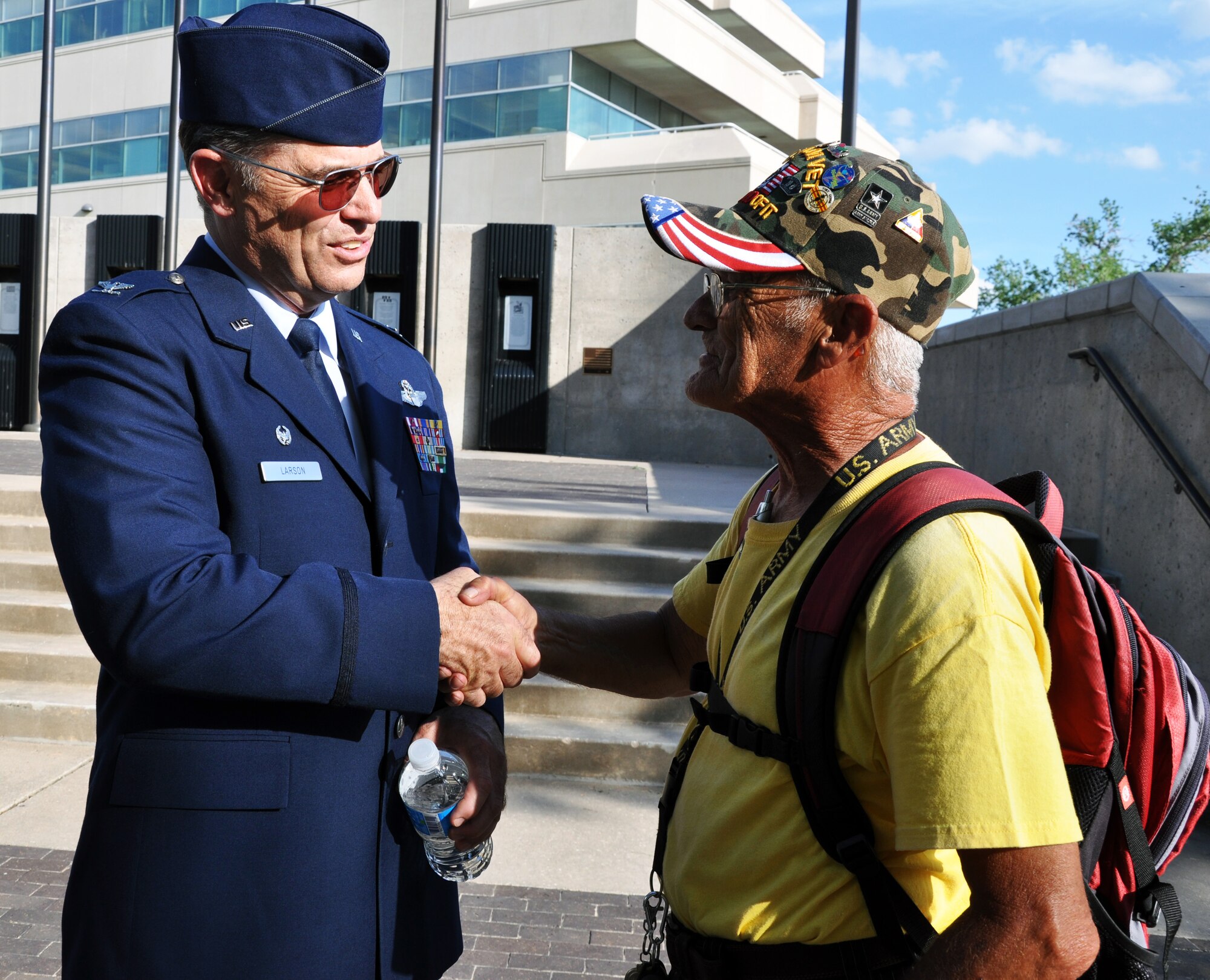 Col. Mark S. Larson, commander of the Air Force Reserve 931st Air Refueling Group, McConnell Air Force Base, Kan., visits with Leslie Maixner, a local Vietnam Veteran, following the Wichita Riverfest Military Salute Ceremony in Wichita, Kan., June 3, 2014.  The annual ceremony pays tribute to past and present members of the U.S. military.  (U.S. Air Force photo by Capt. Zach Anderson)