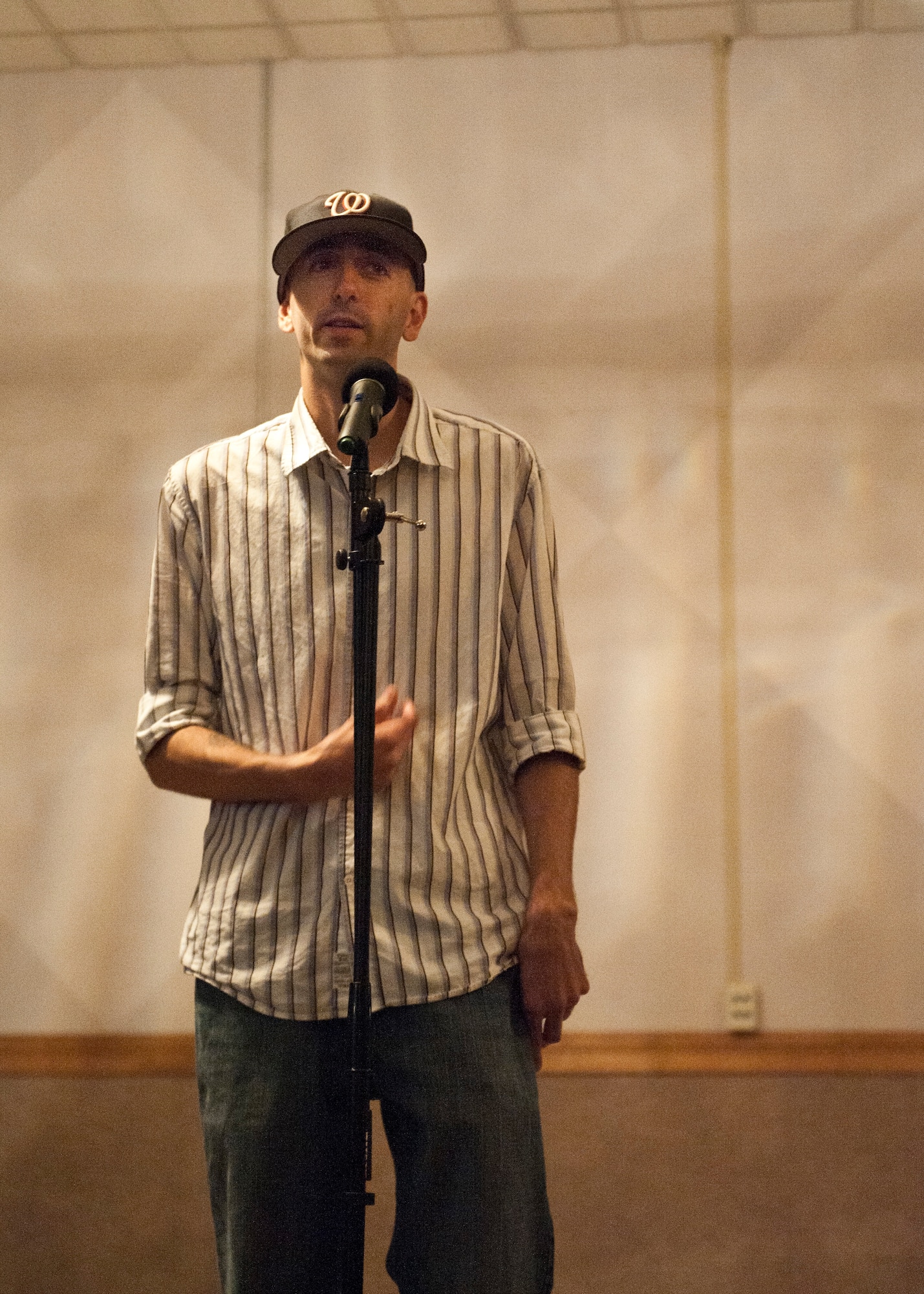 Capt. Heath Wilson, 99th Medical Group nurse, recites a poem during an ‘open mic’ night held by the Asian Pacific American Association at the Time Out Sports Lounge, May 30, 2014, at Nellis Air Force Base, Nev. The APAA celebrates the culture and heritage of Asian Americans and Pacific Islanders in the United States. (U.S. Air Force photo by Airman 1st Class Thomas Spangler)  