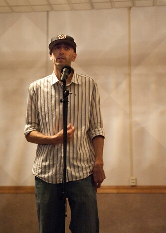 Capt. Heath Wilson, 99th Medical Group nurse, recites a poem during an ‘open mic’ night held by the Asian Pacific American Association at the Time Out Sports Lounge, May 30, 2014, at Nellis Air Force Base, Nev. The APAA celebrates the culture and heritage of Asian Americans and Pacific Islanders in the United States. (U.S. Air Force photo by Airman 1st Class Thomas Spangler)  
