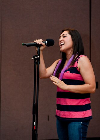 Tech. Sgt. Allison Garces, 706th Fighter Squadron command support section administrator, sings during an ‘open mic’ night held by the Asian Pacific American Association at the Time Out Sports Lounge, May 30, 2014, at Nellis Air Force Base, Nev. The improvisation night was a chance for Airmen to showcase their talents including dancing, singing, and poetry readings. (U.S. Air Force photo by Airman 1st Class Thomas Spangler)