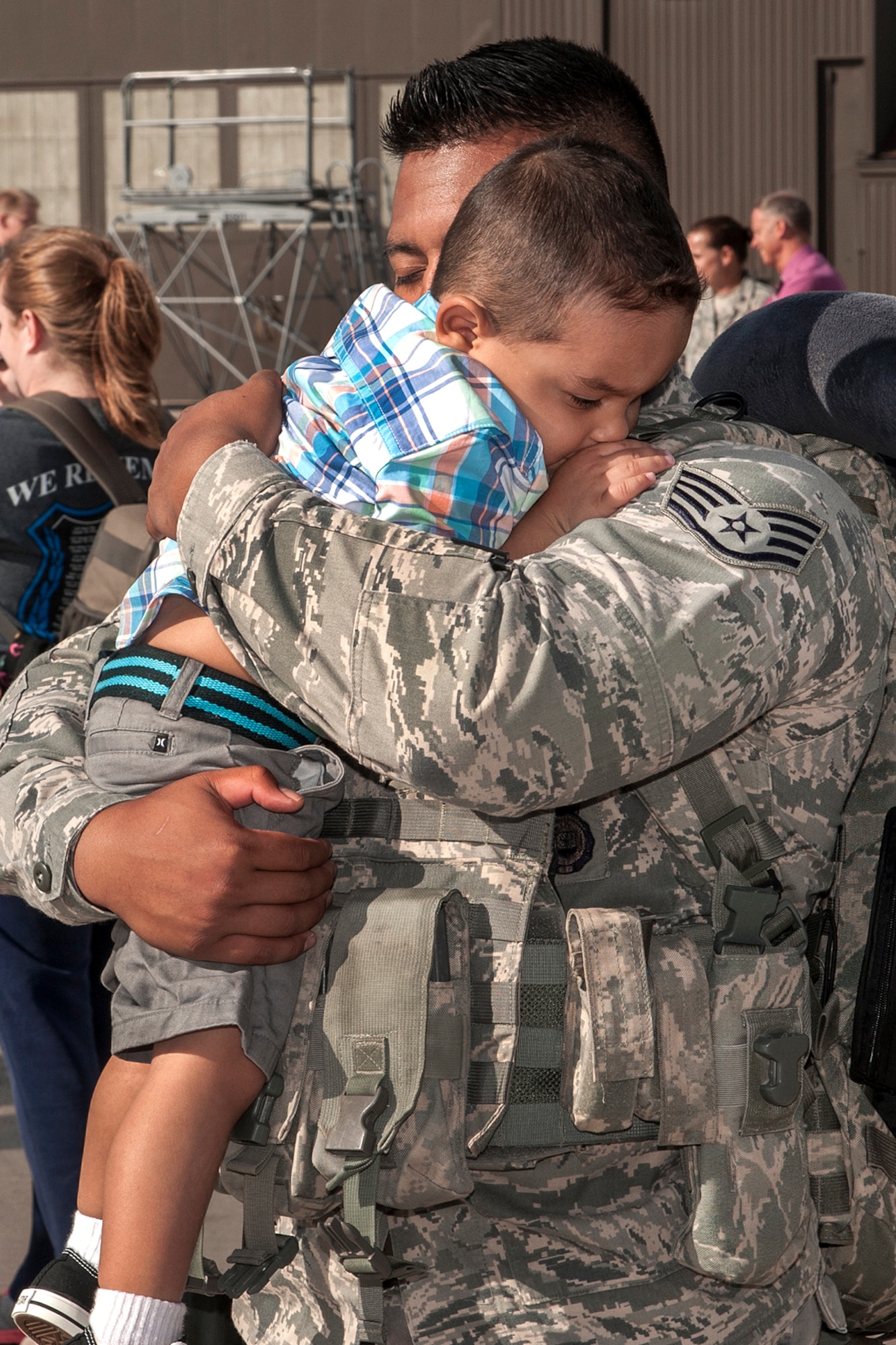 PETERSON AIR FORCE BASE, Colo. – Staff Sgt. Penn Phoung, 21st Security Forces Squadron, hugs his son after returning from a deployment May 30. Phoung was part of a team of Airmen completing deployments to support space control operations with the 17th Expeditionary Space Control Squadron mission to Southwest Asia. (U.S. Air Force photo/Craig Denton)