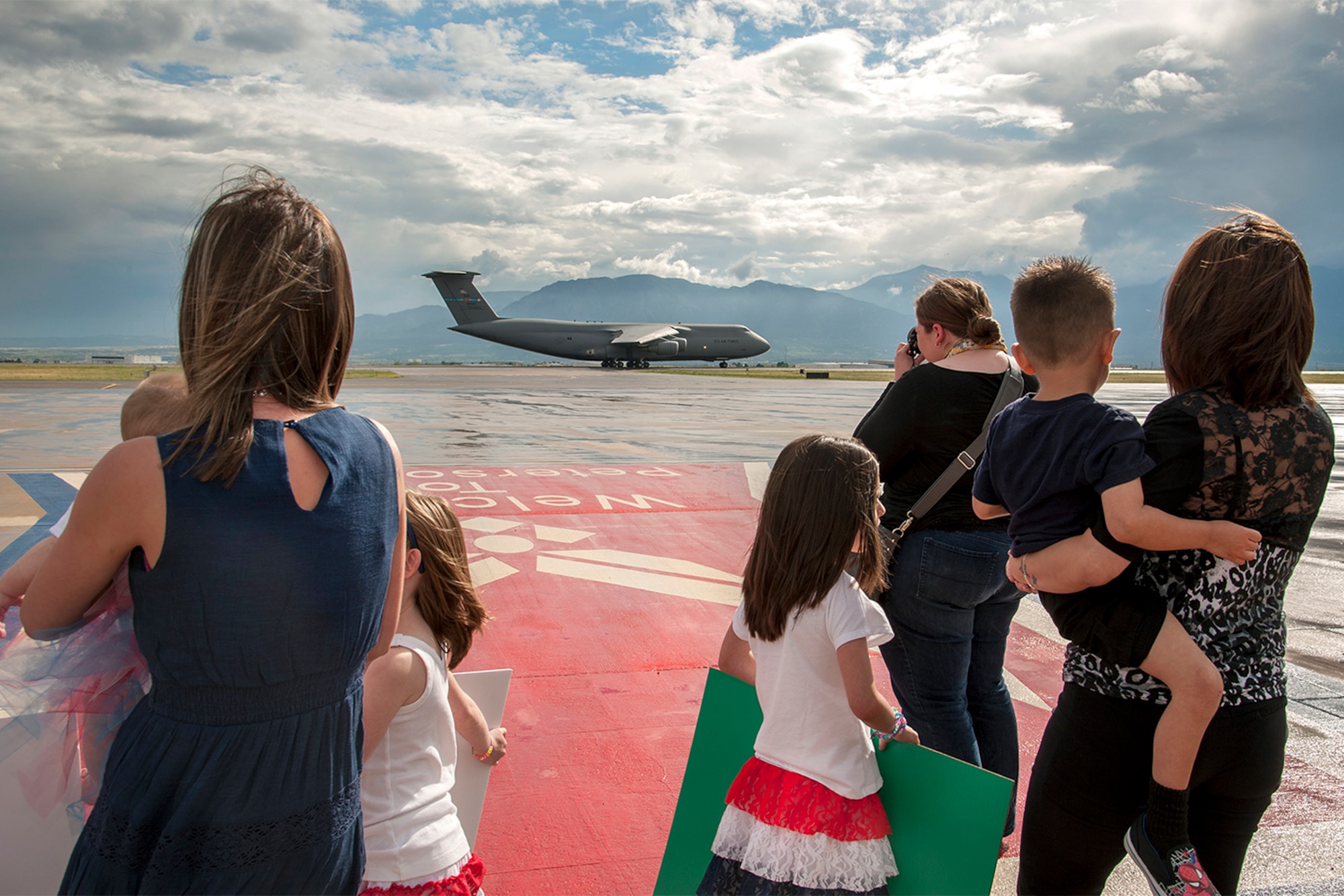 PETERSON AIR FORCE BASE, Colo. – Families anxiously await a C-5 Galaxy carrying returning members of the 21st Security Forces Squadron and 17th Expeditionary Space Control Squadron May 30. The Airmen were completing deployments to support space control operations with the 17th Expeditionary Space Control Squadron mission to Southwest Asia. (U.S. Air Force photo/Craig Denton)