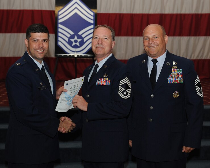 Chief Master Sgt. Bradley Warner, 2nd Aircraft Maintenance Squadron, receives a certificate of promotion from Col. Andrew Gebara, 2nd Bomb Wing commander, and Chief Master Sgt. Stephen Lebrun, 2nd Operations Group, during the May Promotion Ceremony on Barksdale Air Force Base, La., May 30, 2014. (U.S. Air Force photo/Senior Airman Benjamin Gonsier)