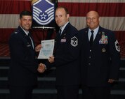 Master Sgt. Nicholas Fisher, 2nd Operations Support Squadron, receives a certificate of promotion from Col. Andrew Gebara, 2nd Bomb Wing commander, and Chief Master Sgt. Stephen Lebrun, 2nd Operations Group, during the May Promotion Ceremony on Barksdale Air Force Base, La., May 30, 2014. (U.S. Air Force photo/Senior Airman Benjamin Gonsier)