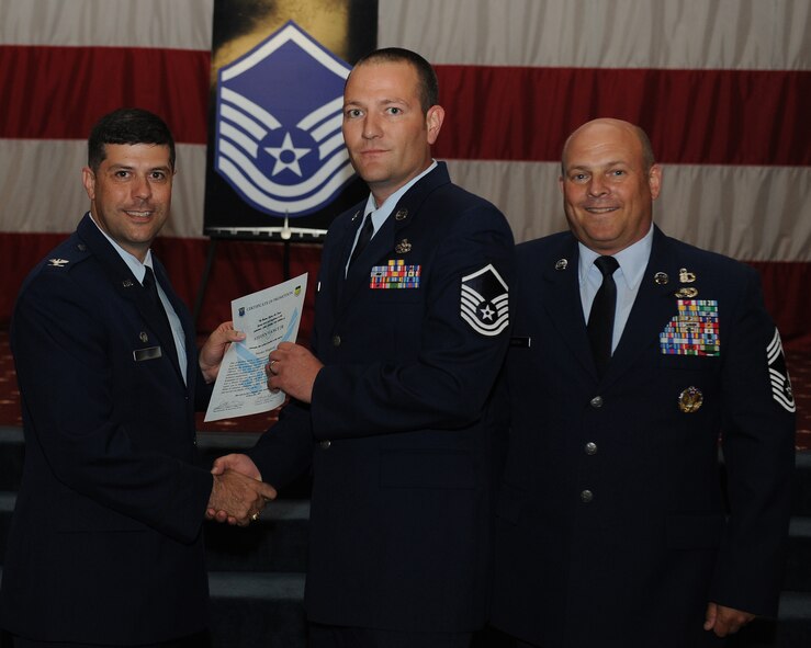 Master Sgt. Steven Vance Jr., 2nd Maintenance Group, receives a certificate of promotion from Col. Andrew Gebara, 2nd Bomb Wing commander, and Chief Master Sgt. Stephen Lebrun, 2nd Operations Group, during the May Promotion Ceremony on Barksdale Air Force Base, La., May 30, 2014. (U.S. Air Force photo/Senior Airman Benjamin Gonsier)