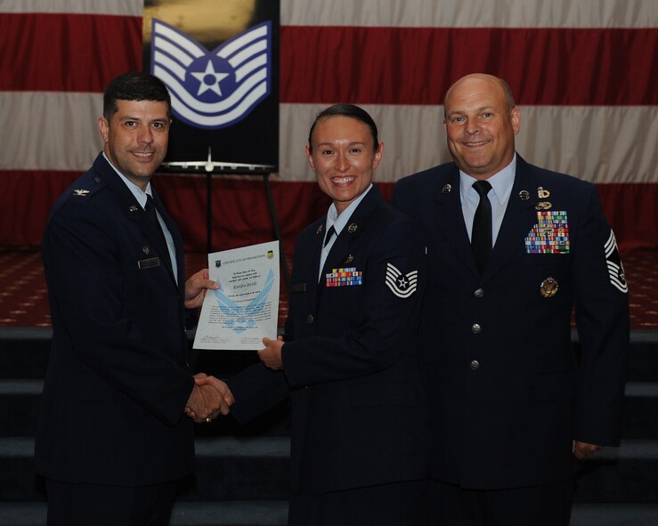Tech. Sgt. Randa Head, 2nd Munitions Squadron, receives a certificate of promotion from Col. Andrew Gebara, 2nd Bomb Wing commander, and Chief Master Sgt. Stephen Lebrun, 2nd Operations Group, during the May Promotion Ceremony on Barksdale Air Force Base, La., May 30, 2014. (U.S. Air Force photo/Senior Airman Benjamin Gonsier)