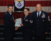 Tech. Sgt. Megan Nelson, 2nd Aircraft Maintenance Squadron, receives a certificate of promotion from Col. Andrew Gebara, 2nd Bomb Wing commander, and Chief Master Sgt. Stephen Lebrun, 2nd Operations Group, during the May Promotion Ceremony on Barksdale Air Force Base, La., May 30, 2014. (U.S. Air Force photo/Senior Airman Benjamin Gonsier)