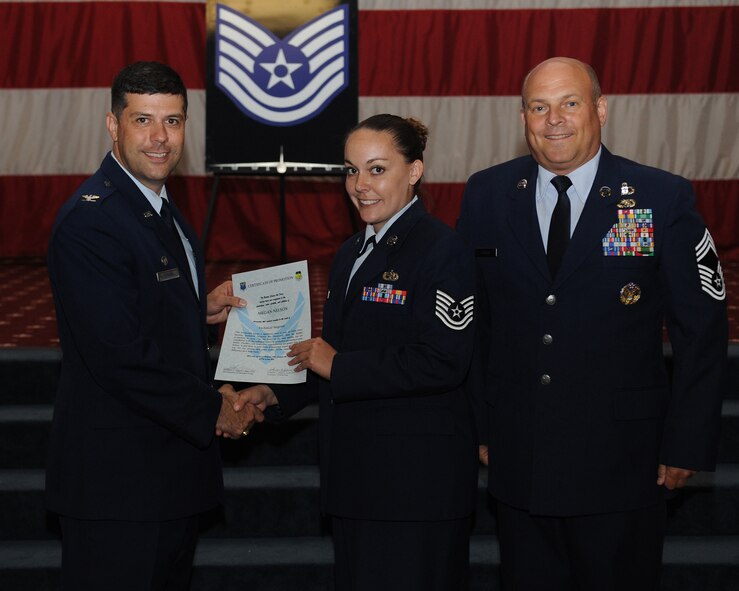 Tech. Sgt. Megan Nelson, 2nd Aircraft Maintenance Squadron, receives a certificate of promotion from Col. Andrew Gebara, 2nd Bomb Wing commander, and Chief Master Sgt. Stephen Lebrun, 2nd Operations Group, during the May Promotion Ceremony on Barksdale Air Force Base, La., May 30, 2014. (U.S. Air Force photo/Senior Airman Benjamin Gonsier)