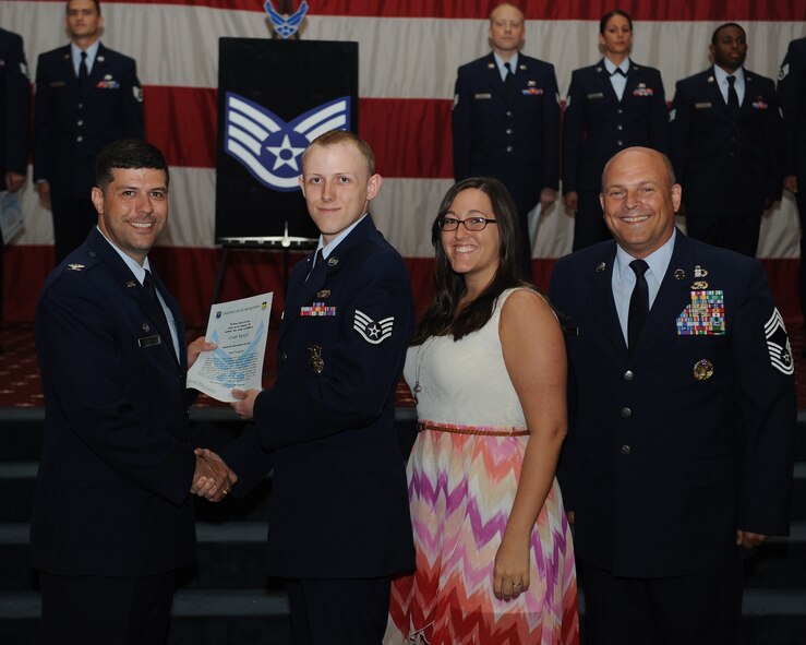 Staff Sgt. Cody Neale, 2nd Security Forces Squadron, receives a certificate of promotion from Col. Andrew Gebara, 2nd Bomb Wing commander, and Chief Master Sgt. Stephen Lebrun, 2nd Operations Group, during the May Promotion Ceremony on Barksdale Air Force Base, La., May 30, 2014. (U.S. Air Force photo/Senior Airman Benjamin Gonsier)