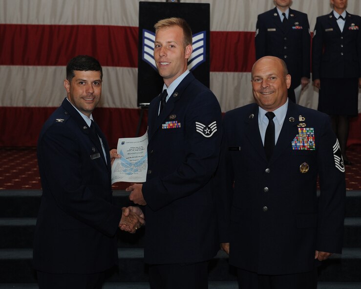 Staff Sgt. Bradley Clott, 2nd Security Forces Squadron, receives a certificate of promotion from Col. Andrew Gebara, 2nd Bomb Wing commander, and Chief Master Sgt. Stephen Lebrun, 2nd Operations Group, during the May Promotion Ceremony on Barksdale Air Force Base, La., May 30, 2014. (U.S. Air Force photo/Senior Airman Benjamin Gonsier)