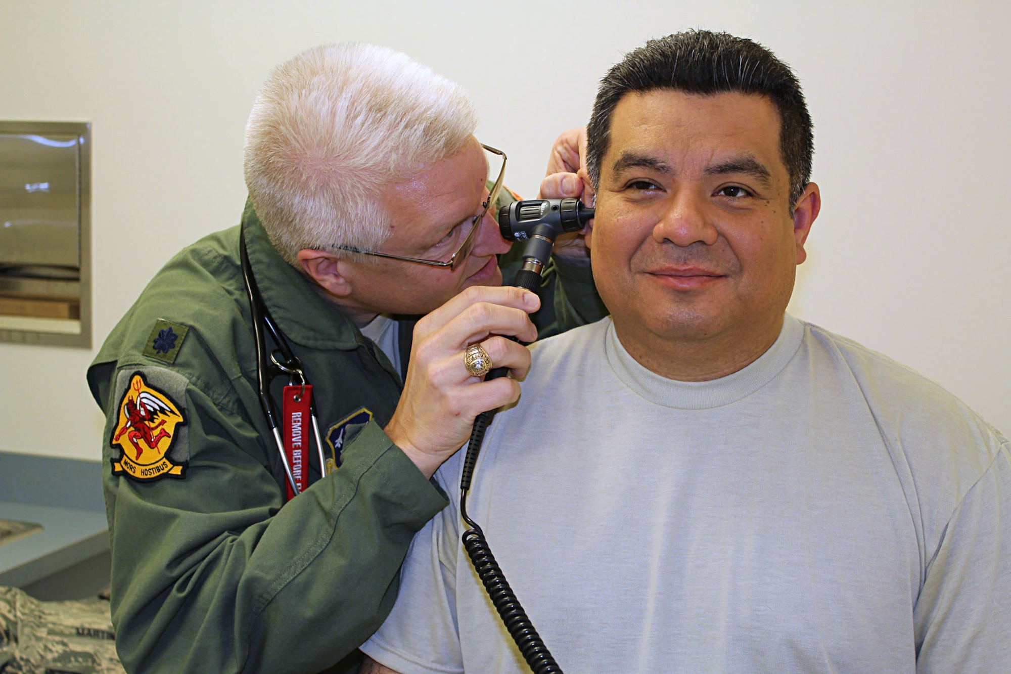 Lt. Col. (Dr.) Brian Schroeder examines Staff Sgt. Ernest Martinez at Selfridge Air National Guard Base, Mich., May 17, 2014. Schroeder is a physician with the 127th Medical Group, which is tasked with ensuring the medical readiness of the Airmen assigned to the 127th Wing, Michigan Air National Guard, at Selfridge. Martinez is a member of the 127th Logistics Readiness Squadron at Selfridge. (U.S. Air National Guard photo by Technical Sgt. Dan Heaton / Released)