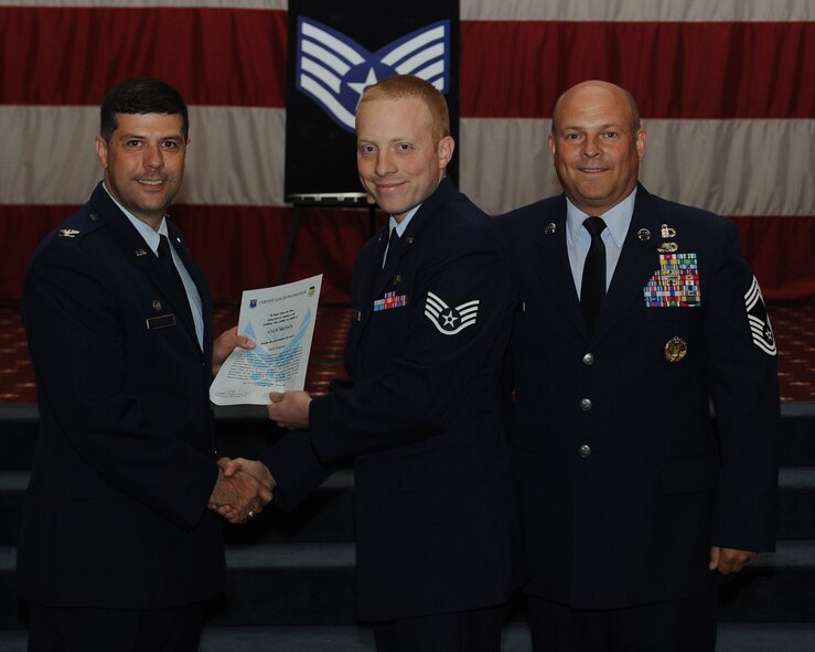 Staff Sgt. Andy Brown, 2nd Maintenance Squadron, receives a certificate of promotion from Col. Andrew Gebara, 2nd Bomb Wing commander, and Chief Master Sgt. Stephen Lebrun, 2nd Operations Group, during the May Promotion Ceremony on Barksdale Air Force Base, La., May 30, 2014. (U.S. Air Force photo/Senior Airman Benjamin Gonsier)
