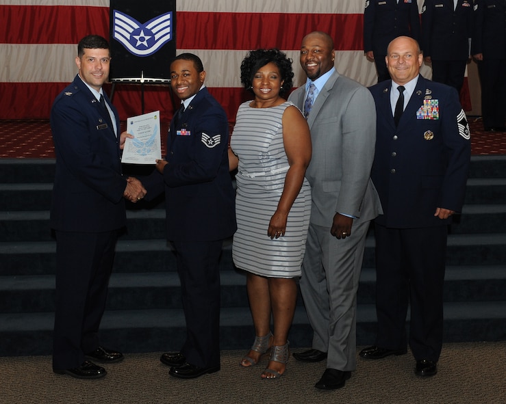 Staff Sgt. Aaron Alford, 2nd Force Support Squadron, receives a certificate of promotion from Col. Andrew Gebara, 2nd Bomb Wing commander, and Chief Master Sgt. Stephen Lebrun, 2nd Operations Group, during the May Promotion Ceremony on Barksdale Air Force Base, La., May 30, 2014. (U.S. Air Force photo/Senior Airman Benjamin Gonsier)