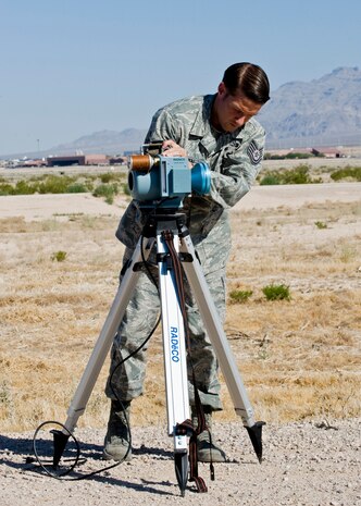 Tech. Sgt. Dan Hansen, 99th Civil Engineer Squadron NCO in charge of emergency management, uses a RADēCO air sampler during the U.S. Air Force Weapons School integration exercise May 30, 2014, at Nellis Air Force Base, Nev.  The RADēCO air samplers are used in remote monitoring programs, emergency planning and health physics departments at nuclear power plants and research facilities in the United States, Canada, Mexico, Europe and Asia.  The instruments detect if there is any radiation in the air.  (U.S Air Force photo by Senior Airman Jason Couillard)