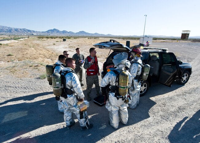 Master Sgt. Michael Wobser, 99th Civil Engineer Squadron fire department assistant chief of operations, speaks to Airmen during the U.S. Air Force Weapons School integration exercise, May 30, 2014, at Nellis Air Force Base, Nev. Airmen throughout the Air Force are put through various exercise scenarios to help ensure their capabilities are ready to be used at a moment’s notice. The exercise included an aircraft mishap, mock casualties and a mock accident involving hazardous materials.  (U.S. Air Force photo by Senior Airman Jason Couillard)