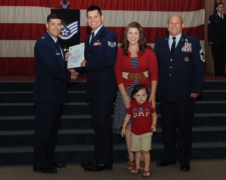 Staff Sgt. Pashala Lewis, 2nd Civil Engineer Squadron, receives a certificate of promotion from Col. Andrew Gebara, 2nd Bomb Wing commander, and Chief Master Sgt. Stephen Lebrun, 2nd Operations Group, during the May Promotion Ceremony on Barksdale Air Force Base, La., May 30, 2014. (U.S. Air Force photo/Senior Airman Benjamin Gonsier)