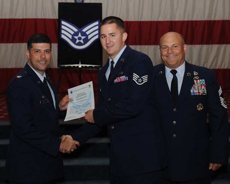 Staff Sgt. Benjamin Elliot, 2nd Aircraft Maintenance Squadron, receives a certificate of promotion from Col. Andrew Gebara, 2nd Bomb Wing commander, and Chief Master Sgt. Stephen Lebrun, 2nd Operations Group, during the May Promotion Ceremony on Barksdale Air Force Base, La., May 30, 2014. (U.S. Air Force photo/Senior Airman Benjamin Gonsier)