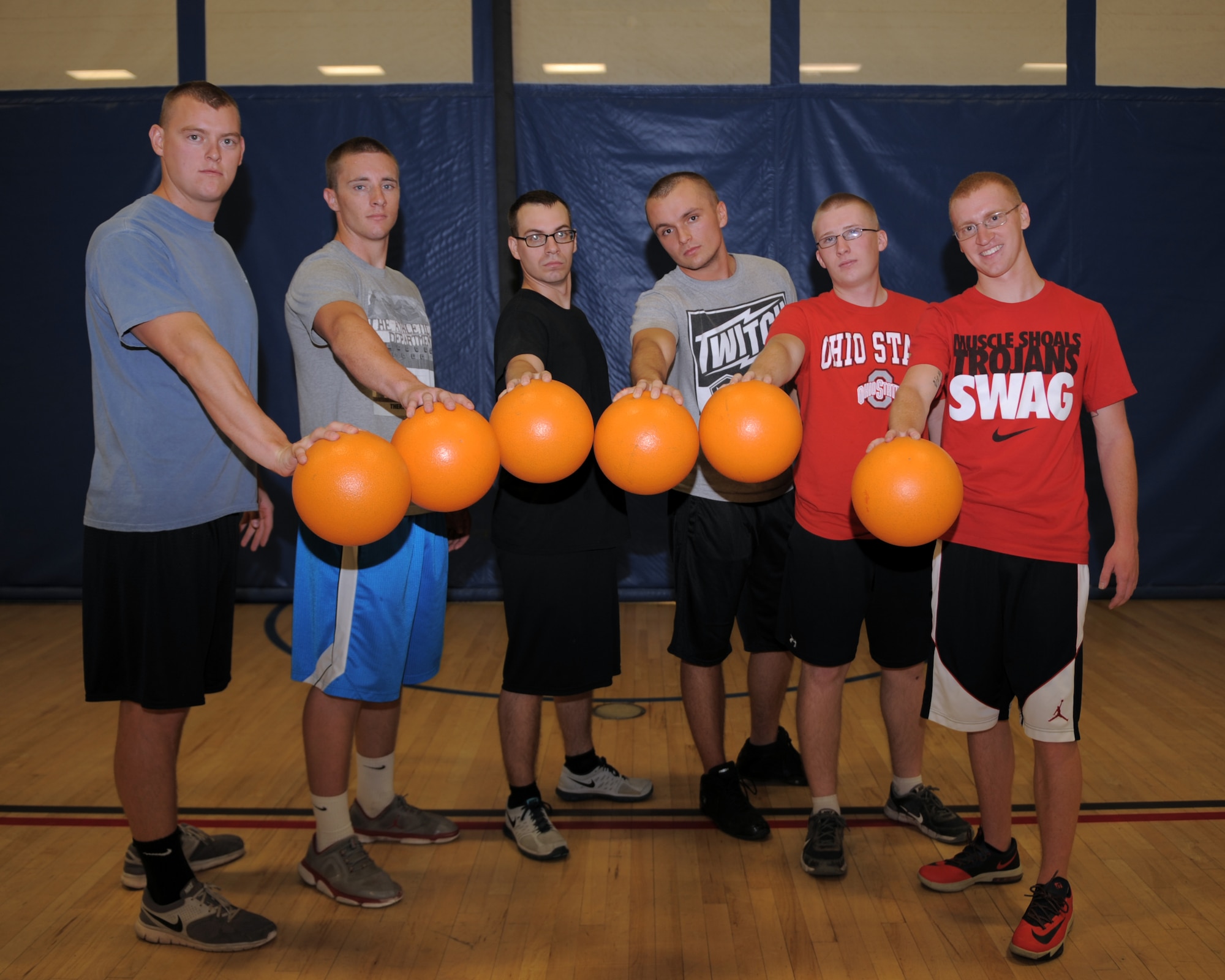 U.S. Air Force Airmen from the 355th Equipment Maintenance Squadron pose for a group photo after winning a dodgeball tournament at Davis-Monthan Air Force Base, Ariz., June 2, 2014. The tournament was part of a Social Comprehensive Airmen Fitness Day intended to build and fortify friendships among Airmen through group activities. (U.S. Air Force photo by Airman 1st Class Chris Drzazgowski/Released)