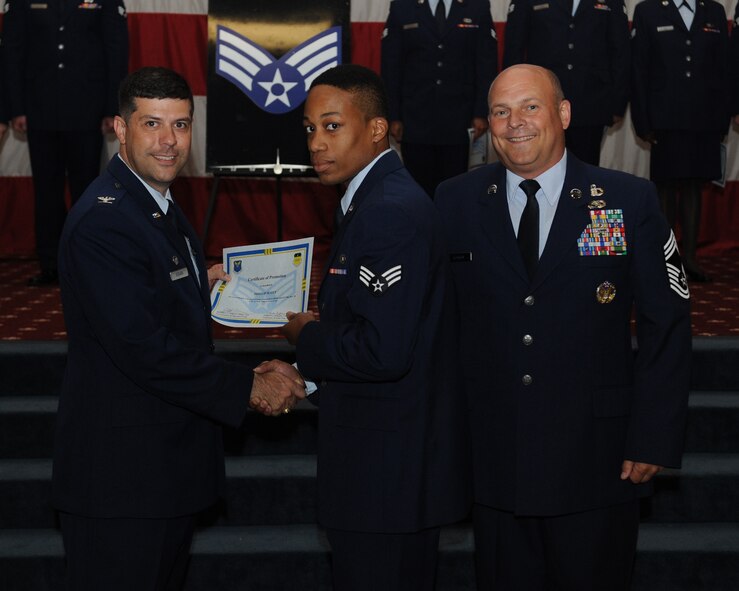 Senior Airman Phillip Scott, 20th Bomb Squadron, receives a certificate of promotion from Col. Andrew Gebara, 2nd Bomb Wing commander, and Chief Master Sgt. Stephen Lebrun, 2nd Operations Group, during the May Promotion Ceremony on Barksdale Air Force Base, La., May 30, 2014. (U.S. Air Force photo/Senior Airman Benjamin Gonsier)