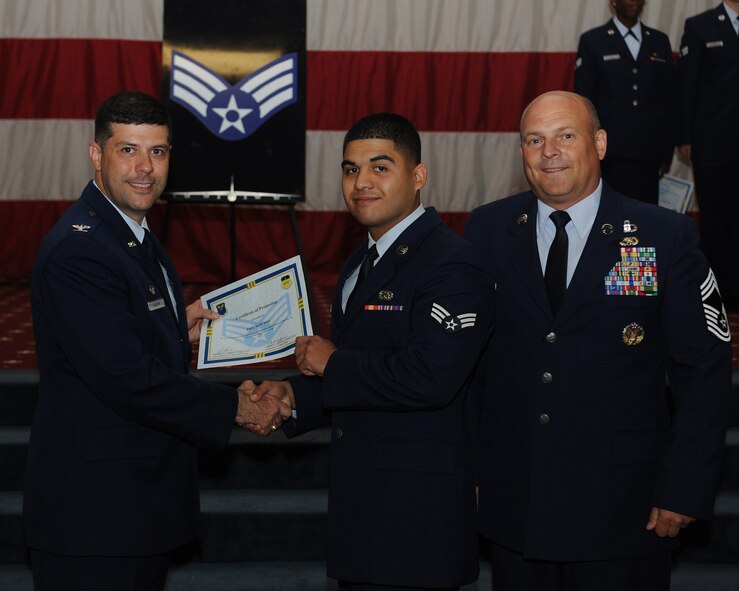 Senior Airman Eric Sanchez, 2nd Logistics Readiness Squadron, receives a certificate of promotion from Col. Andrew Gebara, 2nd Bomb Wing commander, and Chief Master Sgt. Stephen Lebrun, 2nd Operations Group, during the May Promotion Ceremony on Barksdale Air Force Base, La., May 30, 2014. (U.S. Air Force photo/Senior Airman Benjamin Gonsier)