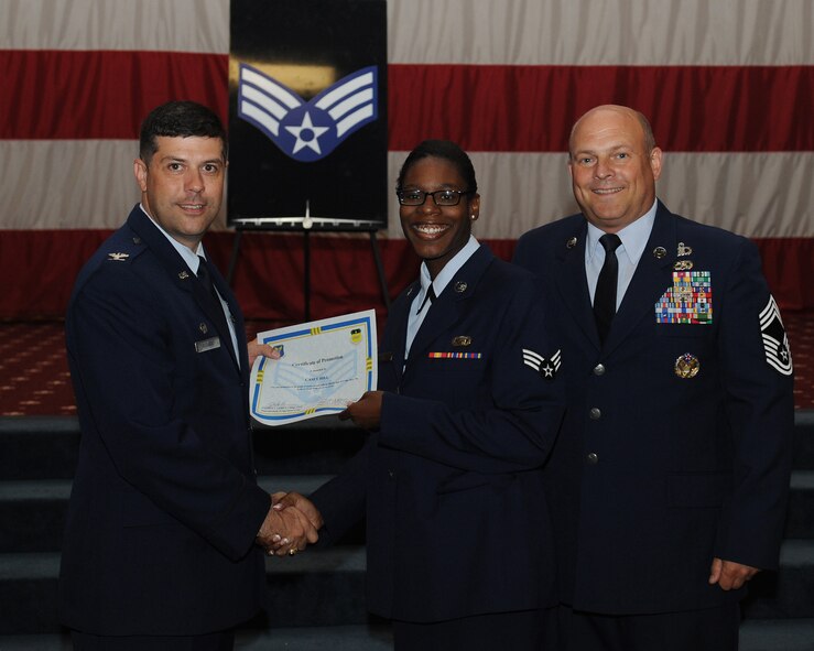 Senior Airman Casey Hill, 2nd Force Support Squadron, receives a certificate of promotion from Col. Andrew Gebara, 2nd Bomb Wing commander, and Chief Master Sgt. Stephen Lebrun, 2nd Operations Group, during the May Promotion Ceremony on Barksdale Air Force Base, La., May 30, 2014. (U.S. Air Force photo/Senior Airman Benjamin Gonsier)