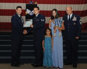 Senior Airman Rafael Paid Gonzalez, 2nd Aircraft Maintenance Squadron, receives a certificate of promotion from Col. Andrew Gebara, 2nd Bomb Wing commander, and Chief Master Sgt. Stephen Lebrun, 2nd Operations Group, during the May Promotion Ceremony on Barksdale Air Force Base, La., May 30, 2014. (U.S. Air Force photo/Senior Airman Benjamin Gonsier)