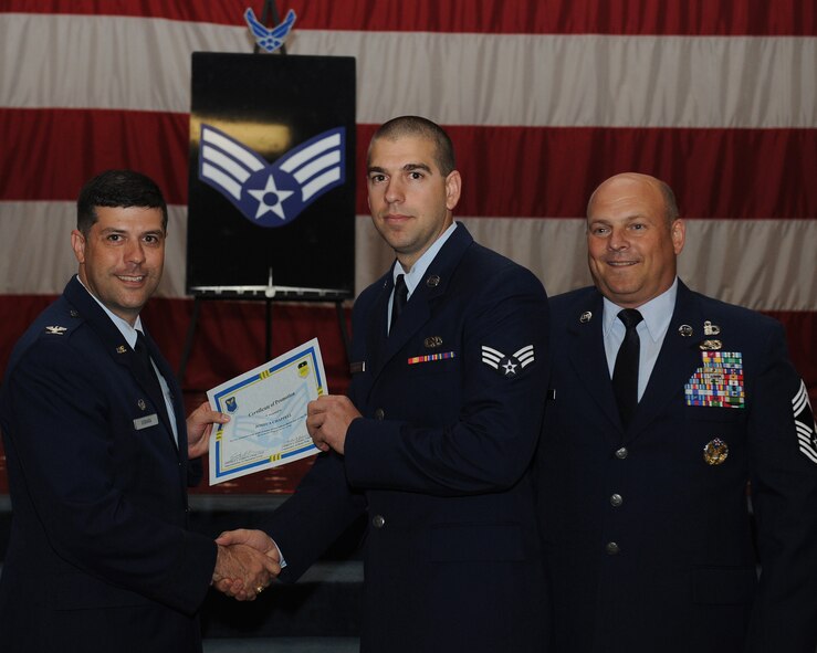 Senior Airman Joshua Chappell, 2nd Aircraft Maintenance Squadron, receives a certificate of promotion from Col. Andrew Gebara, 2nd Bomb Wing commander, and Chief Master Sgt. Stephen Lebrun, 2nd Operations Group, during the May Promotion Ceremony on Barksdale Air Force Base, La., May 30, 2014. (U.S. Air Force photo/Senior Airman Benjamin Gonsier)