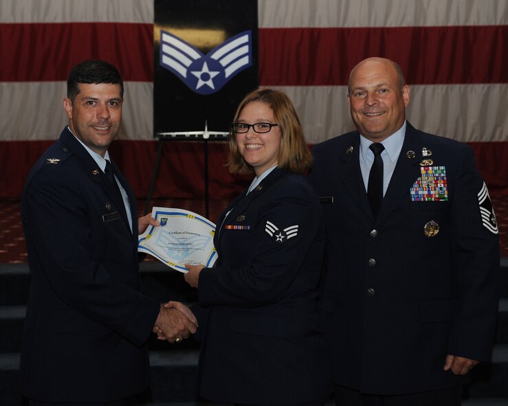 Senior Airman Marissa Armstrong, 2nd Aircraft Maintenance Squadron, receives a certificate of promotion from Col. Andrew Gebara, 2nd Bomb Wing commander, and Chief Master Sgt. Stephen Lebrun, 2nd Operations Group, during the May Promotion Ceremony on Barksdale Air Force Base, La., May 30, 2014. (U.S. Air Force photo/Senior Airman Benjamin Gonsier)