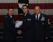 Senior Airman Numan Rana, 11th Bomb Squadron, receives a certificate of promotion from Col. Andrew Gebara, 2nd Bomb Wing commander, and Chief Master Sgt. Stephen Lebrun, 2nd Operations Group, during the May Promotion Ceremony on Barksdale Air Force Base, La., May 30, 2014. (U.S. Air Force photo/Senior Airman Benjamin Gonsier)