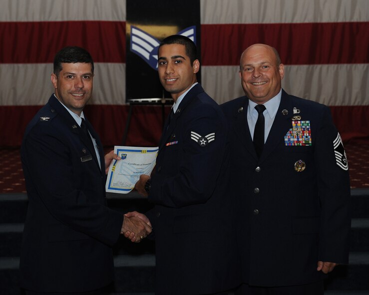 Senior Airman Numan Rana, 11th Bomb Squadron, receives a certificate of promotion from Col. Andrew Gebara, 2nd Bomb Wing commander, and Chief Master Sgt. Stephen Lebrun, 2nd Operations Group, during the May Promotion Ceremony on Barksdale Air Force Base, La., May 30, 2014. (U.S. Air Force photo/Senior Airman Benjamin Gonsier)