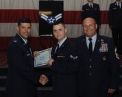 Airman 1st Class Robert Brown, 26th Operational Weather Squadron, receives a certificate of promotion from Col. Andrew Gebara, 2nd Bomb Wing commander, and Chief Master Sgt. Stephen Lebrun, 2nd Operations Group, during the May Promotion Ceremony on Barksdale Air Force Base, La., May 30, 2014. (U.S. Air Force photo/Senior Airman Benjamin Gonsier)