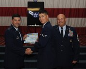 Airman 1st Class Scott Jarrott, 2nd Maintenance Squadron, receives a certificate of promotion from Col. Andrew Gebara, 2nd Bomb Wing commander, and Chief Master Sgt. Stephen Lebrun, 2nd Operations Group, during the May Promotion Ceremony on Barksdale Air Force Base, La., May 30, 2014. (U.S. Air Force photo/Senior Airman Benjamin Gonsier)