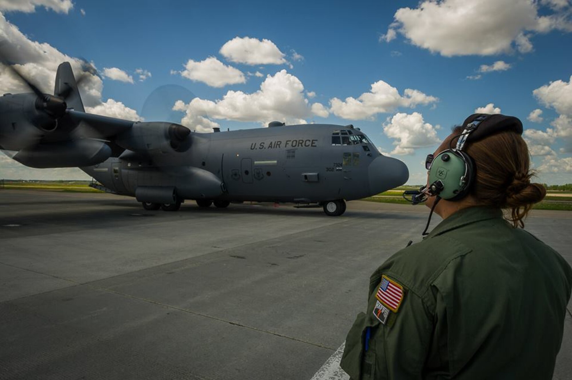 U.S. Air Force Master Sgt. Nattessa Tolle, C-130 Hercules loadmaster with the 302nd Airlift Wing, Peterson Air Force Base, Colo., observes engine startup during Maple Flag in Edmonton/Cold Lake, Alberta, Canada, June 2, 2014. Maple Flag is an international exercise designed to enhance the interoperability of C-130 aircrews, maintainers and support specialists in a simulated combat environment. (U.S. Air Force photo by Master Sgt. John R. Nimmo, Sr./Released) 4th Combat Camera Squadron— at Edmonton International Airport.