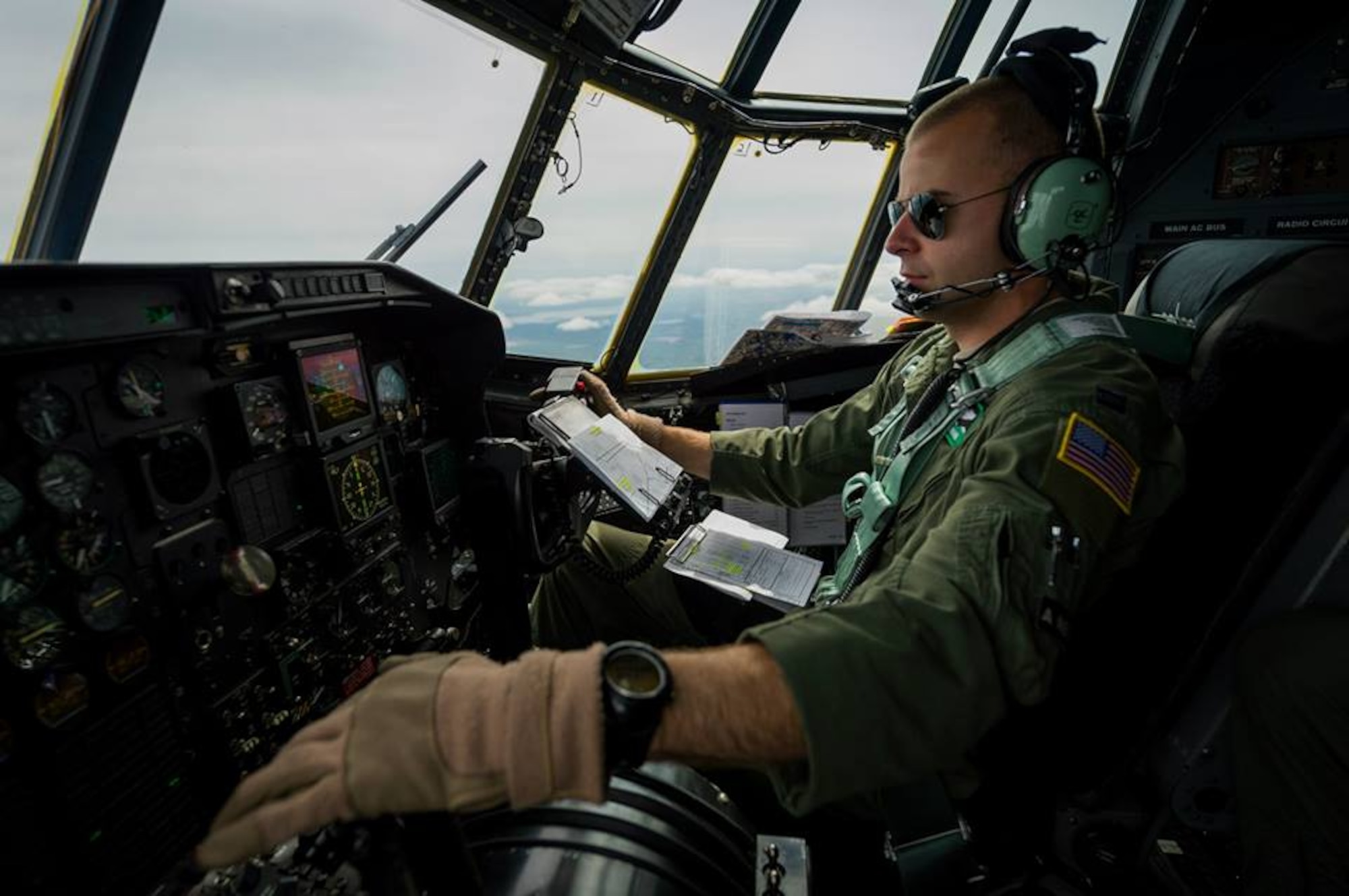 U.S. Air Force Capt. Eric Dahlmann, C-130 Hercules co-pilot with the 302nd Airlift Wing, Peterson Air Force Base, Colo., mans the flight controls while on a station keeping equipment mission during Maple Flag in Edmonton/Cold Lake, Alberta, Canada, May 28, 2014. Maple Flag is an international exercise designed to enhance the interoperability of C-130 aircrews, maintainers and support specialists in a simulated combat environment. (U.S. Air Force photo by Master Sgt. John R. Nimmo, Sr./Released) 4th Combat Camera Squadron— at Edmonton International Airport.
