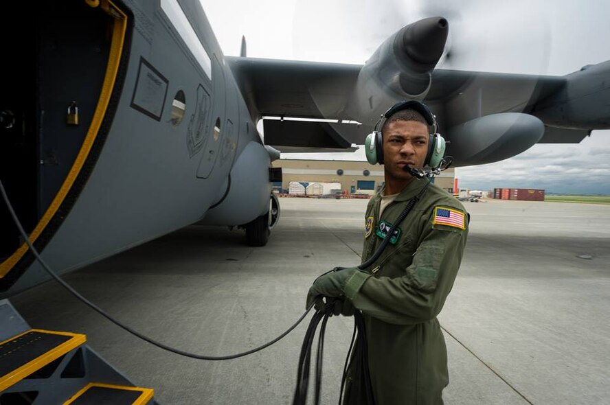 U.S. Air Force Airman 1st Class Quinn Harris, C-130 Hercules loadmaster with the 302nd Airlift Wing, Peterson Air Force Base, Colo., recovers his communication cord following engine startup during Maple Flag in Edmonton/Cold Lake, Alberta, Canada, May 28, 2014. Maple Flag is an international exercise designed to enhance the interoperability of C-130 aircrews, maintainers and support specialists in a simulated combat environment. (U.S. Air Force photo by Master Sgt. John R. Nimmo, Sr./Released) 4th Combat Camera Squadron— with Quinn Harris at Edmonton International Airport. 
