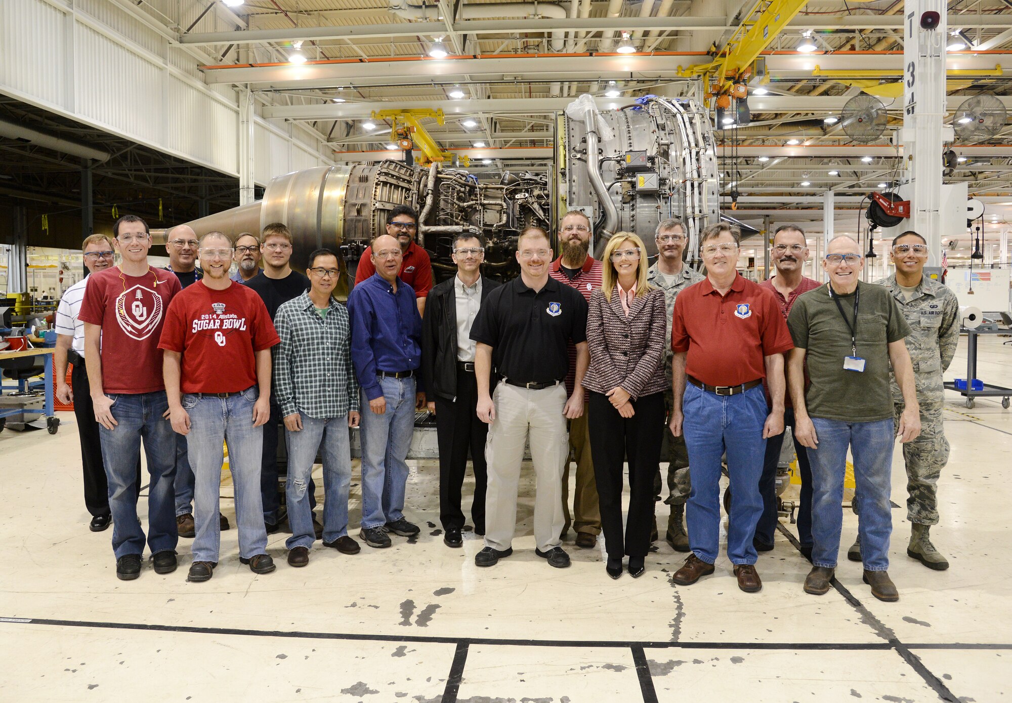 Members of the team that helped implement the CFM Propulsion Upgrade Program to the F108 engines here at Tinker pose with the 100th engine to receive the upgrade. Among the team members are Tim Misner, Air Force Life Cycle Management Center; James Bunyard, 548th Propulsion Maintenance Group; Steve Johnson, AFLCMC; Fred Gonzales, AFLCMC; Paul Waugh, AFLCMC; Brian Johnson, AFLCMC; Justin Summers, AFLCMC; Stephanie Riddle, Air Force Sustainment Center Contracting Directorate Materiel Support Division; Lt. Col. Jesse Warren, AFLCMC; Steve Walsh, AFLCMC; Jeff Inlow, 546th Propulsion Maintenance Squadron; and 2nd Lt. Anders Charry, AFLCMC. (Air Force photo by Kelly White)