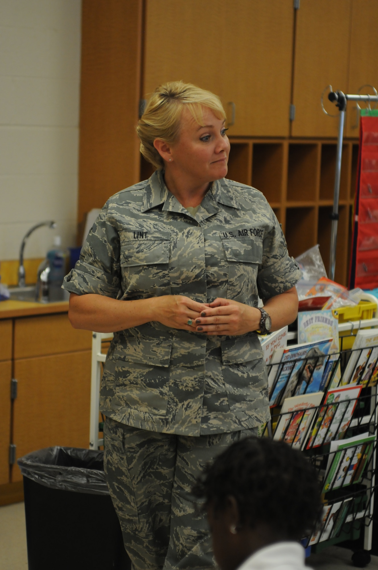 Tech. Sgt. Kalee Lint, Development and Training Flight program manager and executive assistant to the command chief for the 910th Airlift Wing, engages with students at Paul C. Bunn  Elementary School, Youngstown, Ohio, June 2, 2014. Several Service members from Youngstown Air Reserve Station including Airmen, Sailors and Marines volunteered with Junior Achievement to teach elementary school students skills for work readiness, entrepreneurship and financial literacy. U.S. Air Force photo/Mr. Eric M. White