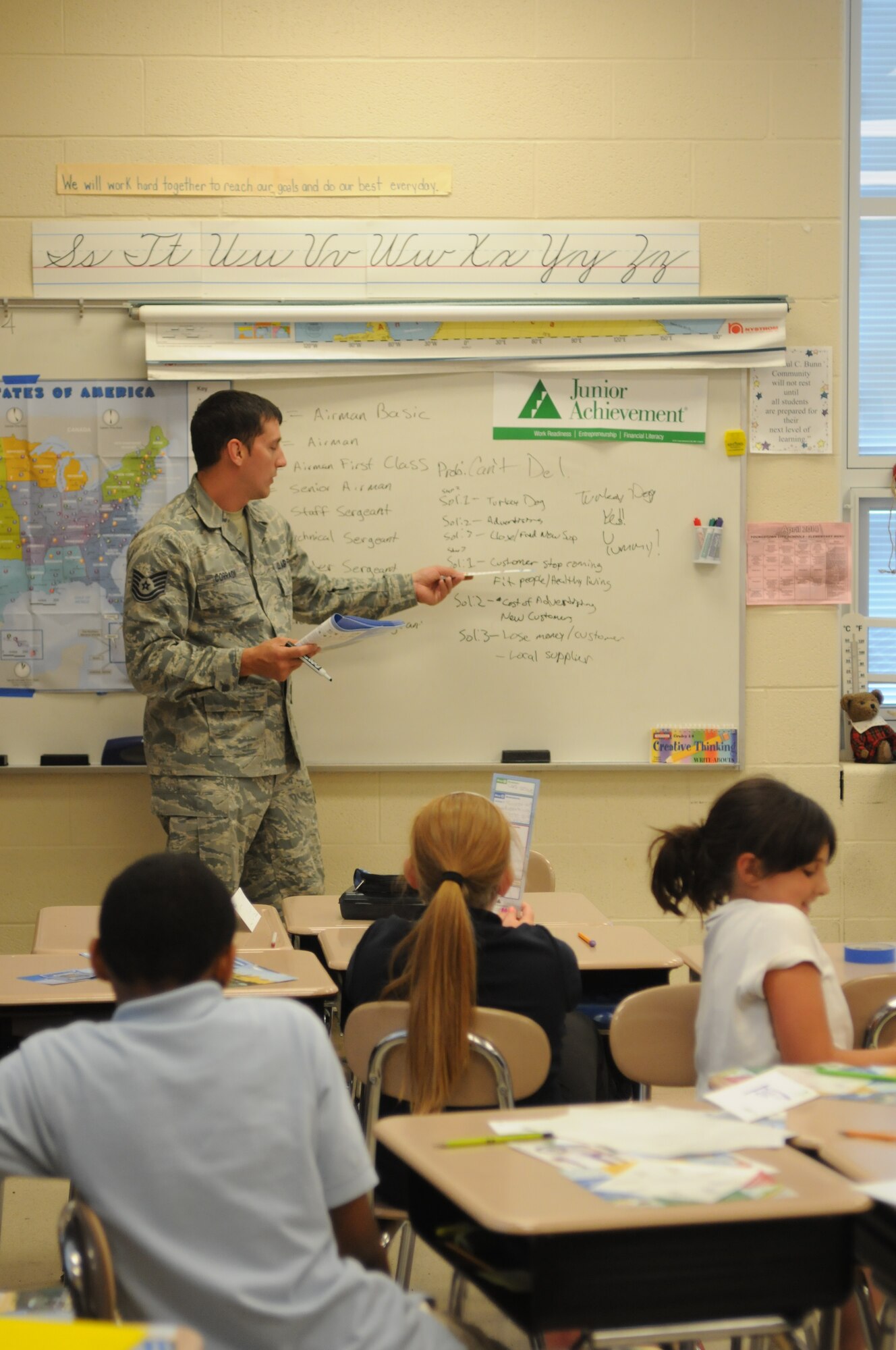 Tech. Sgt. Jason Corradi, an automation specialist with the 910th Mission Support Group, engages with students at Paul C. Bunn  Elementary School, Youngstown, Ohio, June 2, 2014. Several Service members from Youngstown Air Reserve Station including Airmen, Sailors and Marines volunteered with Junior Achievement to teach elementary school students skills for work readiness, entrepreneurship and financial literacy. U.S. Air Force photo/Mr. Eric M. White