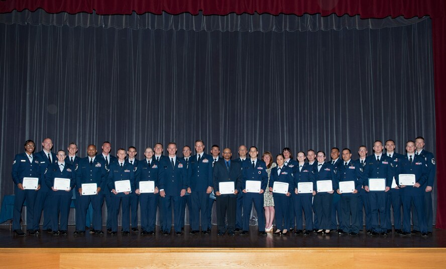 The Community College of the Air Force graduating class of 2014 poses for a group photo May 29, 2014, at the base theater on Dover Air Force Base, Del. (U.S. Air Force photo/Roland Balik)