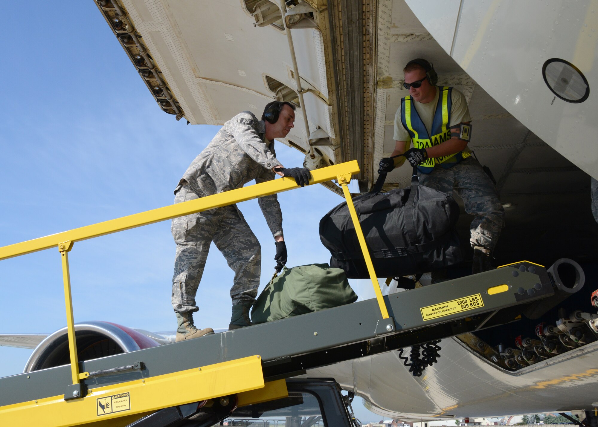 Tech Sgt. Steve Bishop, 175th Logistics Readiness Squadron, unloads bags from a Boeing 767 at Aviano Air Base, Italy, June 4, 2014. Nearly 50 members of the Maryland Air National Guard deployed to Italy to train with their active duty counterparts. (U.S. Air National Guard photo by MSgt. Gareth Buckland/Released)