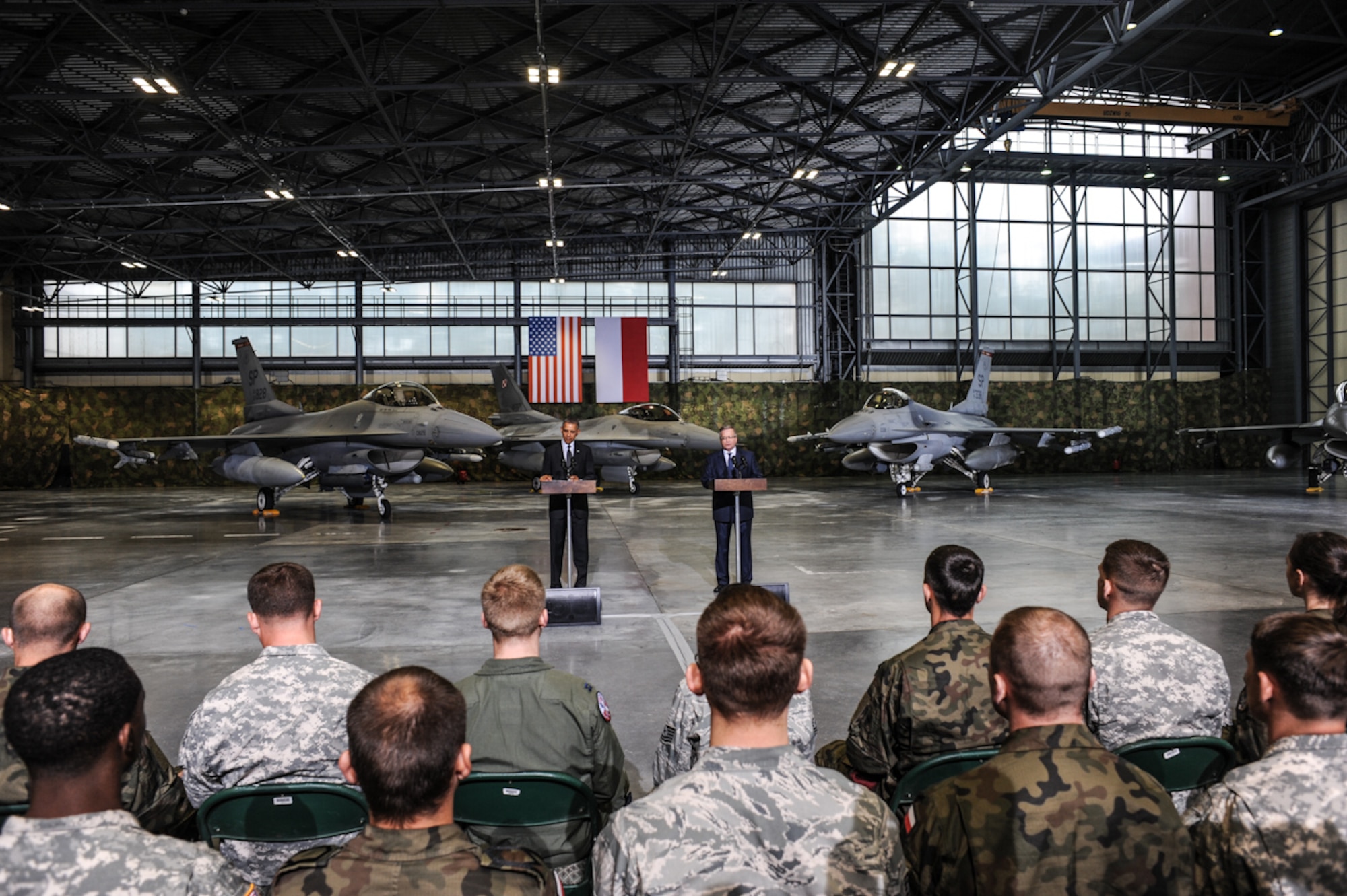 President Barack Obama and Poland’s President Bronisław Komorowski speak to U.S. and Polish service members, June 3, 2014, at the Warsaw Chopin Airport in Warsaw, Poland. The presidents spoke about the two countries’ enduring partnership and commitment to sustaining regional peace and stability. The 52nd Operations Group, Aviation Detachment 1 at Poland’s Lask Air Base is one example of how the United States and Poland are strengthening their interoperability through planned rotational exercises. (Photo courtesy of U.S. Embassy-Warsaw/Released) 