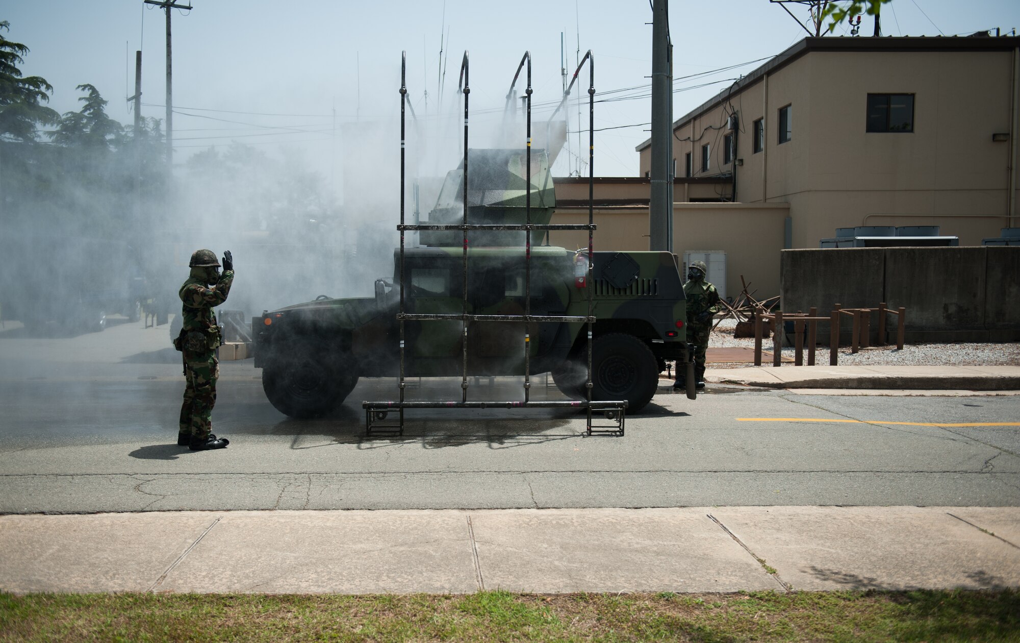 A Republic of Korea Airman guides a Humvee through a decontamination station during a combined exercise at Kunsan Air Base, Republic of Korea, May 28, 2014. This exercise tested the response of the Wolf Pack and RoKaf to a chemical threat. (U.S. Air Force photo by Staff Sgt. Clayton Lenhardt/Released)