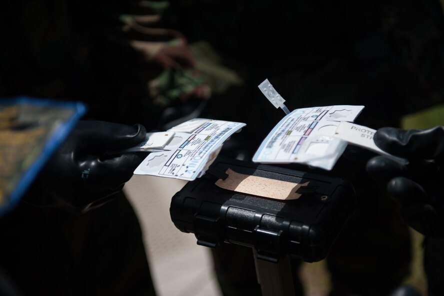 Airmen from the 8th Civil Engineer Squadron and Republic of Korea air force inspect a liquid detection point during a combined exercise at Kunsan Air Base, Republic of Korea, May 28, 2014. This exercise tested the response of the Wolf Pack and RoKaf to a chemical threat. (U.S. Air Force photo by Staff Sgt. Clayton Lenhardt/Released) 