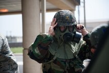 A Republic of Korea air force Airman dons his protective gear during a combined exercise at Kunsan Air Base, Republic of Korea, May 28, 2014. This exercise tested the response of the Wolf Pack and RoKaf to a chemical threat. (U.S. Air Force photo by Staff Sgt. Clayton Lenhardt/Released)