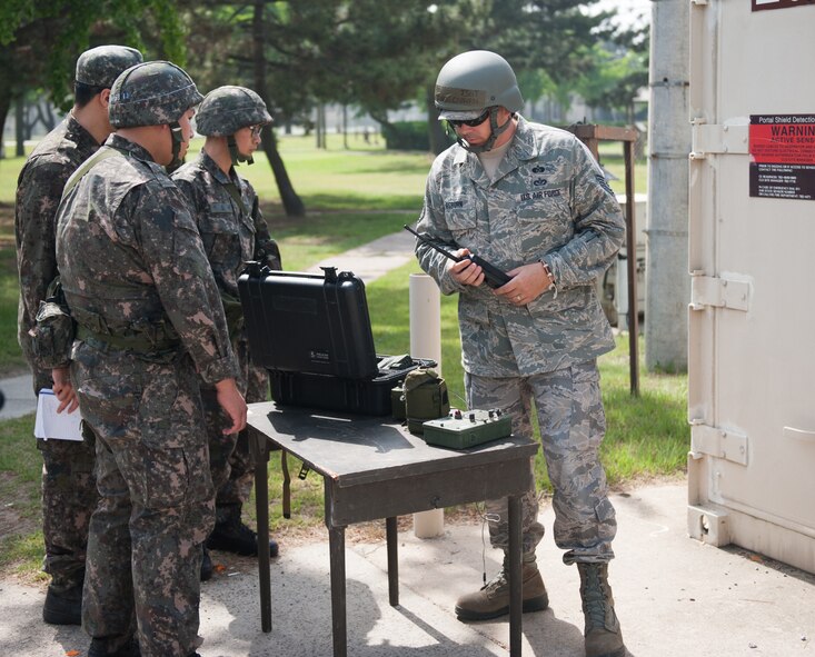 Tech. Sgt. Michael Osburn, 8th Civil Engineer Squadron emergency management training NCOIC, sets up a liquid detection point during a combined exercise at Kunsan Air Base, Republic of Korea, May 28, 2014. This exercise tested the response of the Wolf Pack and Republic of Korea air force to a chemical threat. (U.S. Air Force photo by Staff Sgt. Clayton Lenhardt/Released)