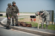 Senior Airman Vincent Nguyen, 8th Civil Engineer Squadron emergency management apprentice, sets up a liquid detection point during a combined exercise at Kunsan Air Base, Republic of Korea, May 28, 2014. This exercise tested the response of the Wolf Pack and Republic of Korea air force to a chemical threat. (U.S. Air Force photo by Staff Sgt. Clayton Lenhardt/Released)