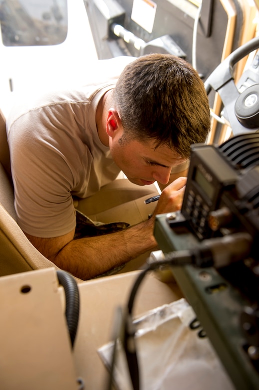 Staff Sgt. Lucas Smith, 82nd Expeditionary Air Support Operations Squadron radio frequency transmissions craftsman deployed from the 682nd ASOS Fort Bragg, N.C., inspects a mine-resistant ambush-protected vehicle for inventory compliance and upgrade requirements.   The expertise of the support functions within an EASOS unit help to ensure mission completion for Joint Terminal Attack Controllers. (U.S. Air Force photo by Staff Sgt. Jeremy Bowcock)