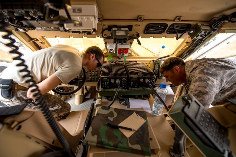 Staff Sgt. Lucas Smith and Staff Sgt. Jacob Jacques, radio frequency transmissions craftsmen from the 82nd Expeditionary Air Support Operations Squadron, inspect a mine-resistant ambush-protected vehicle for inventory compliance and upgrade requirements.   The expertise of the support functions within an EASOS unit help to ensure mission completion for Joint Terminal Attack Controllers. (U.S. Air Force photo by Staff Sgt. Jeremy Bowcock)